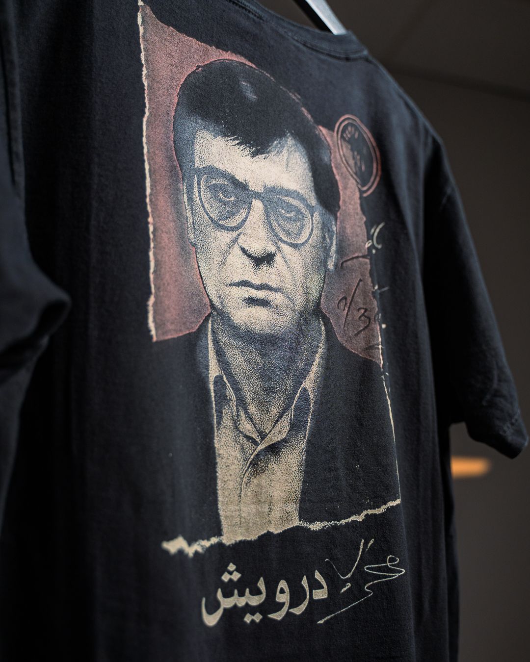 Darwish tee with a portrait of Mahmoud Darwish and his signature